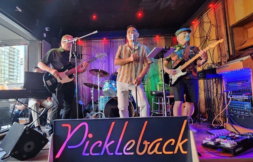 Pickleback on stage with their illuminated logo sign